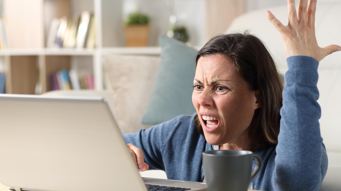 Angry woman yelling at computer © 2021 iStock
