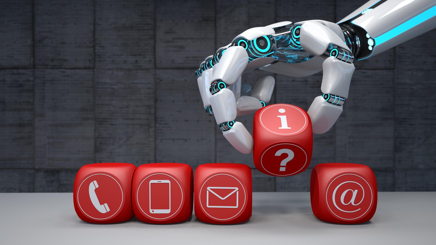 A robot arm with red cubes and contact icons placed on a table © 2020 iStock