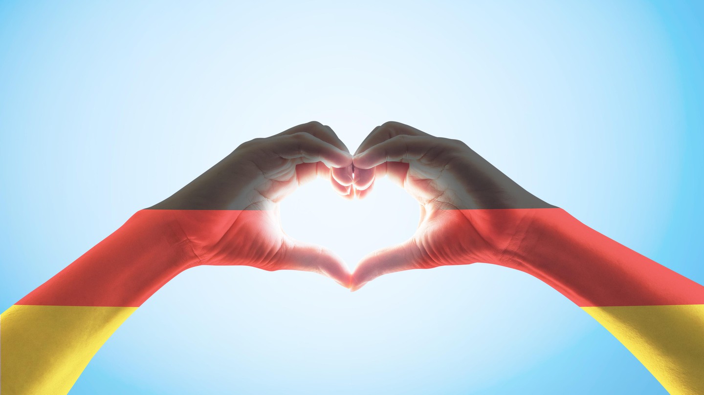 Germany national flag on people heart shape hands© Chinnapong Istock