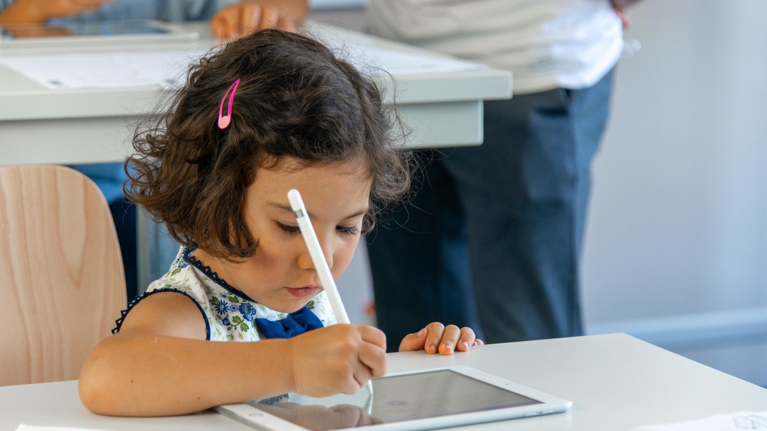 Young girl learning to write © 2021 EPFL