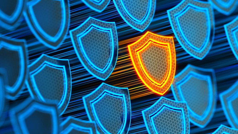 Futuristic digital background with protective glowing yellow shield © iStock