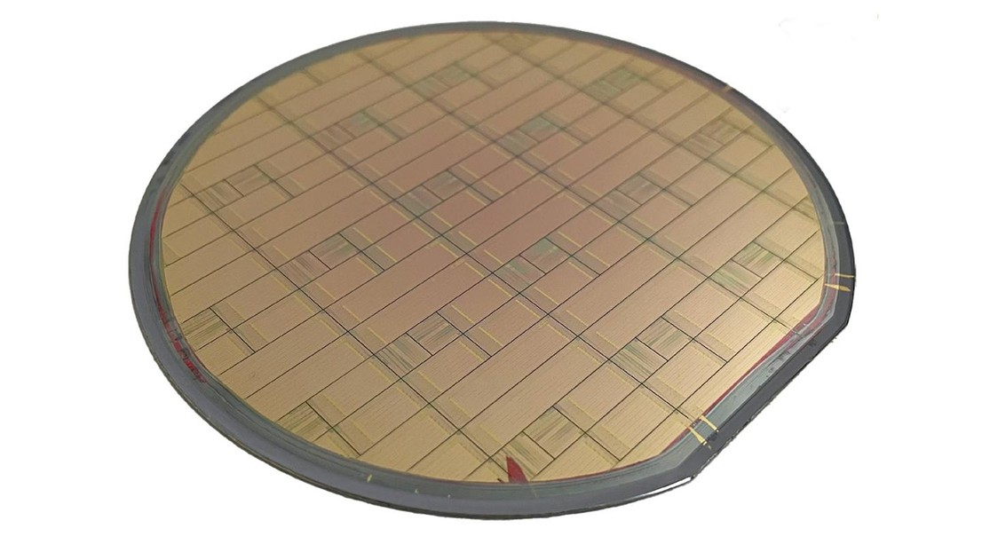 Photograph of a manufactured 100-mm wafer hosting hundreds of copper Damascene lithium tantalate modulators. Credit: Lin et al 2026.