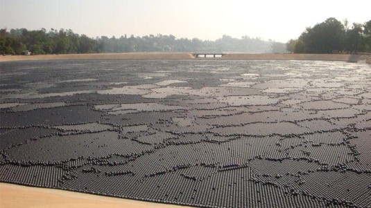 Ponds are sometimes covered by plastic balls, like here in California, to prevent evaporation.