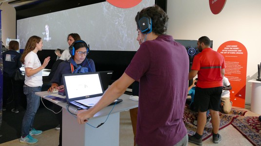 Participants try to guess what chords come next at the digital musicology display © 2019 EPFL